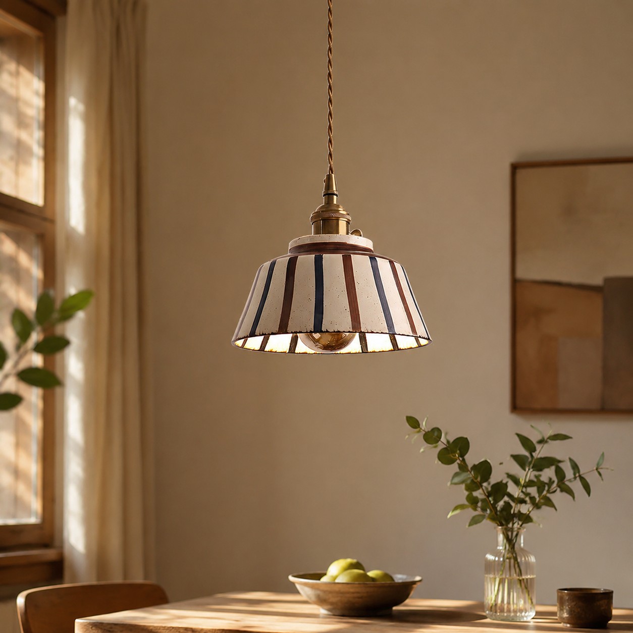 Striped ceramic pendant over a small dining table