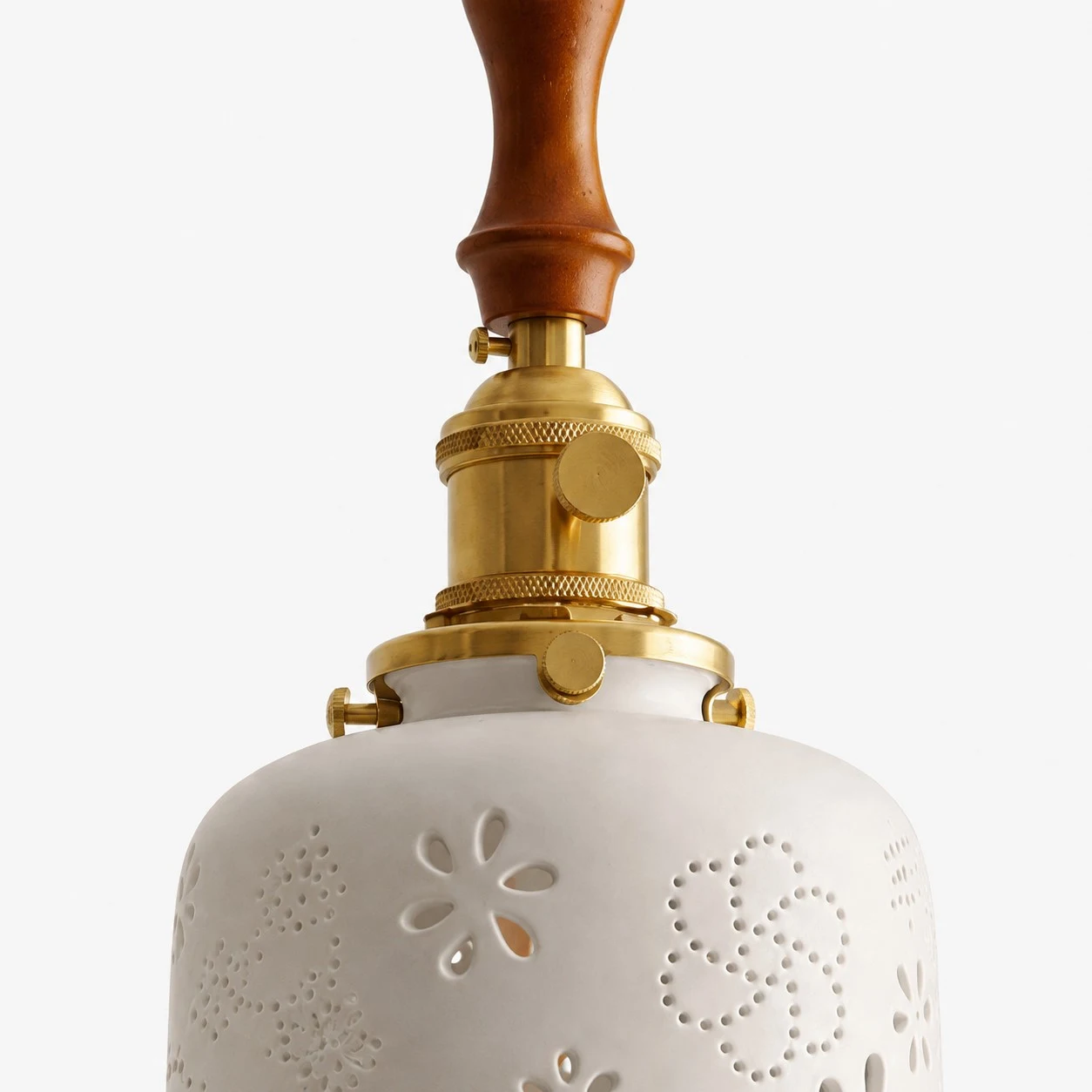 Ceramic lamp with brass top hardware and warm wood accent detail