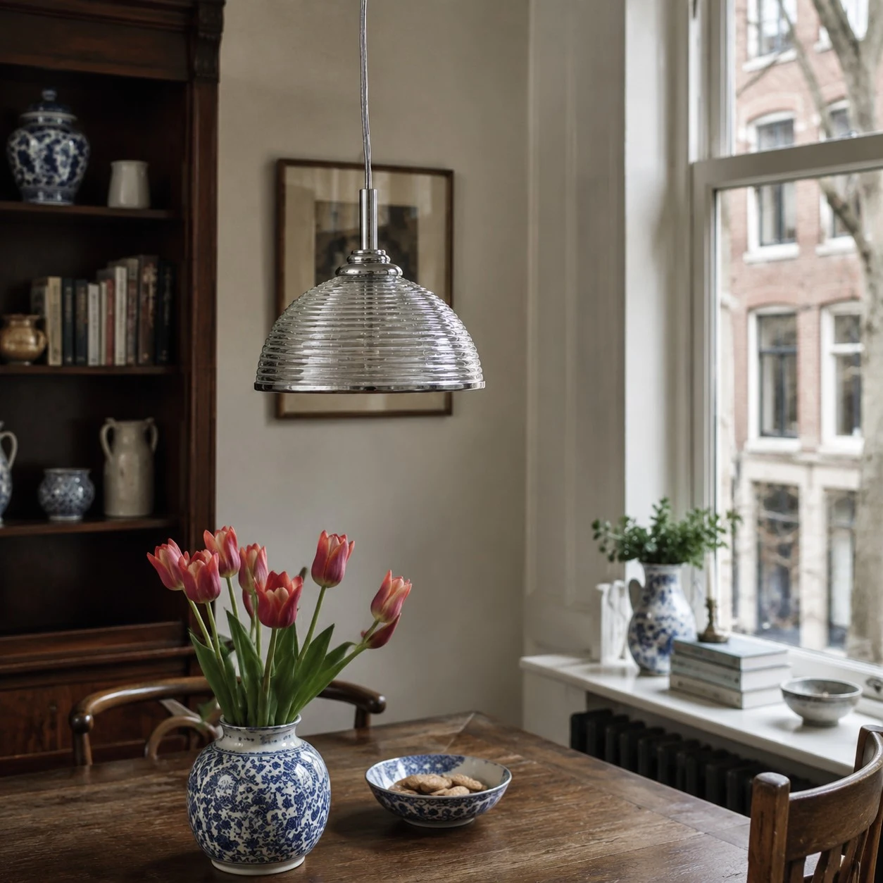 Clear ribbed glass pendant light beside a classic window table