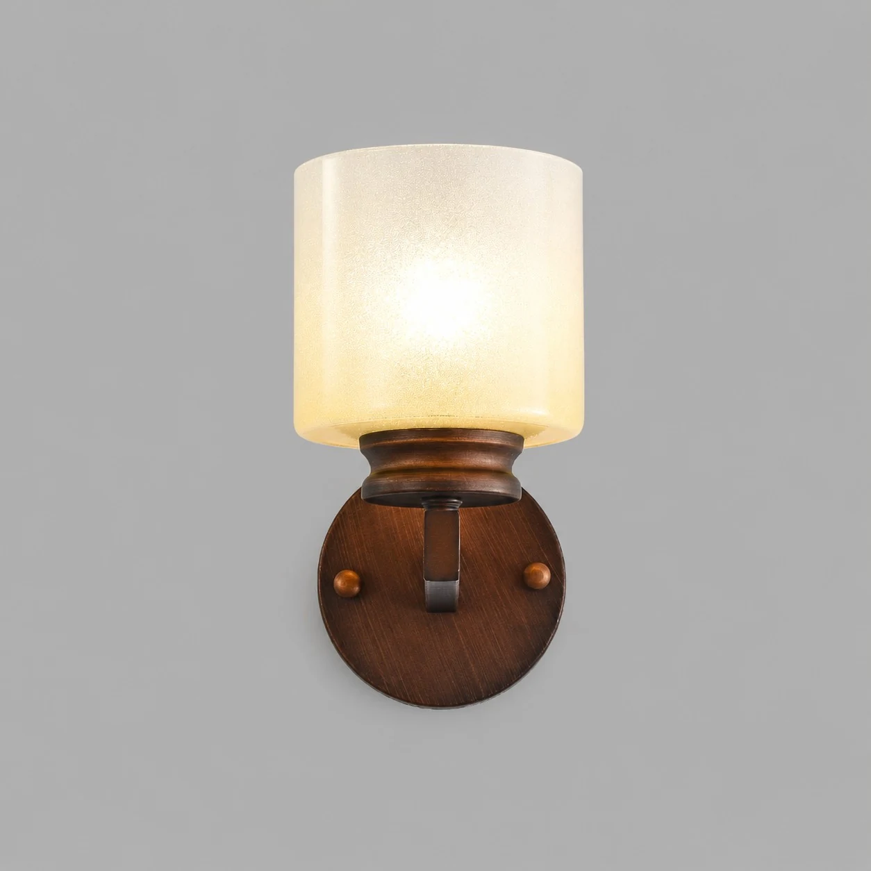 Front view of lit aged bronze alabaster glass wall sconce