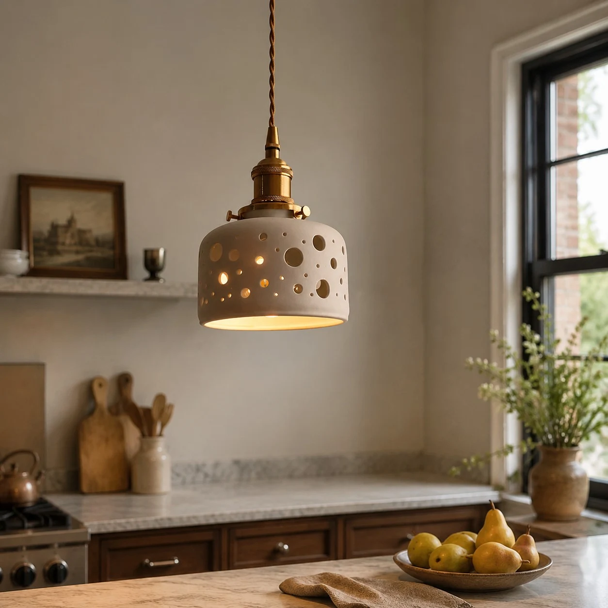 Dot cutout ceramic pendant light over a kitchen counter