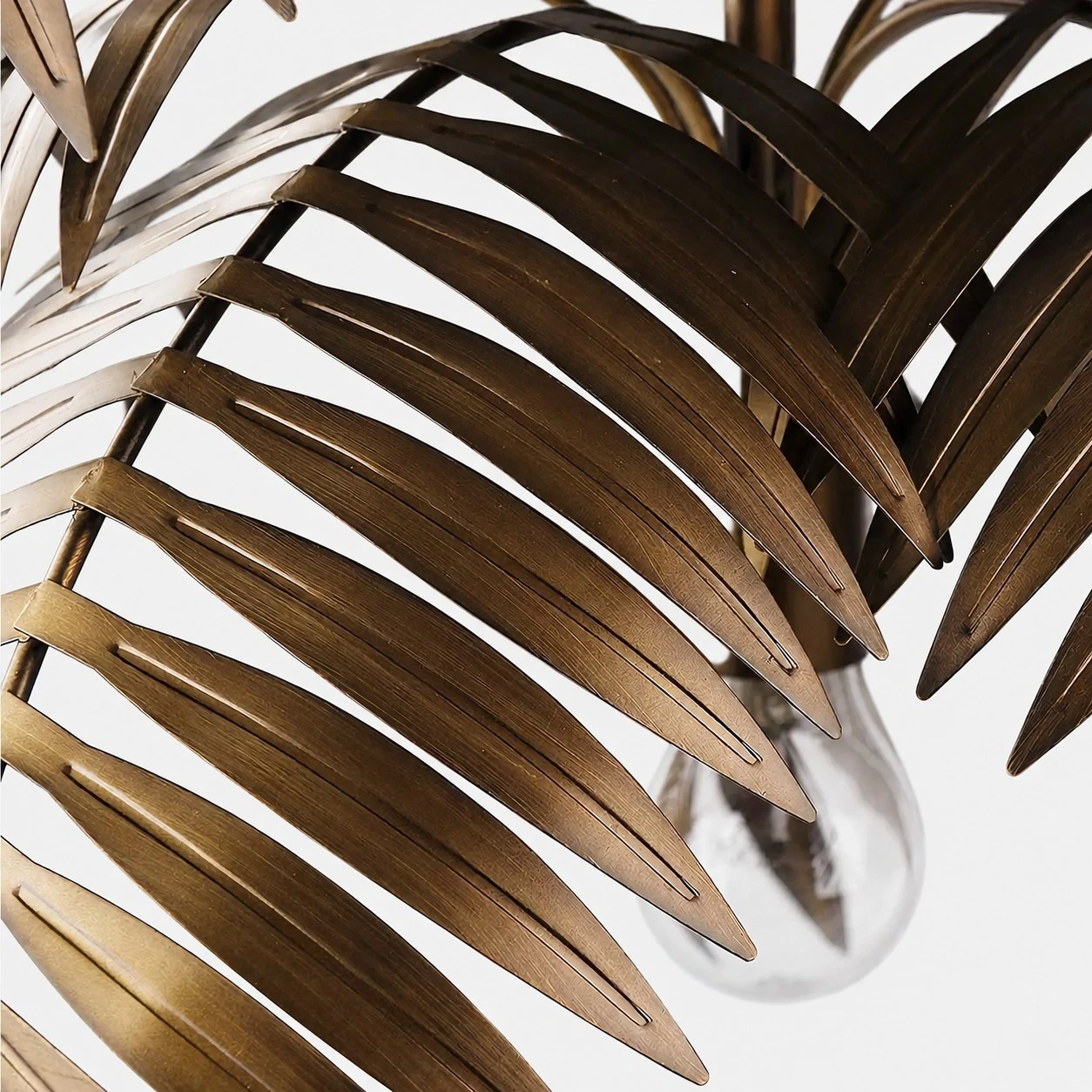 Close view of cut metal leaf edges and layered chandelier structure